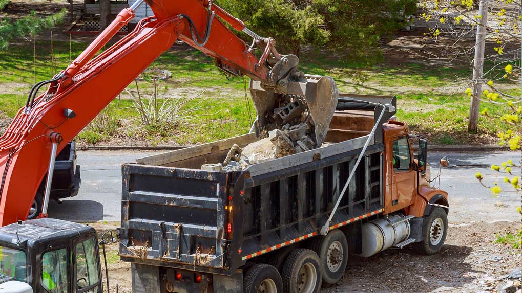 service struck with excavator loading for removal of waste austin tx
